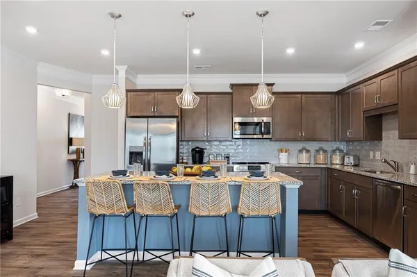 a large kitchen with a table and chairs