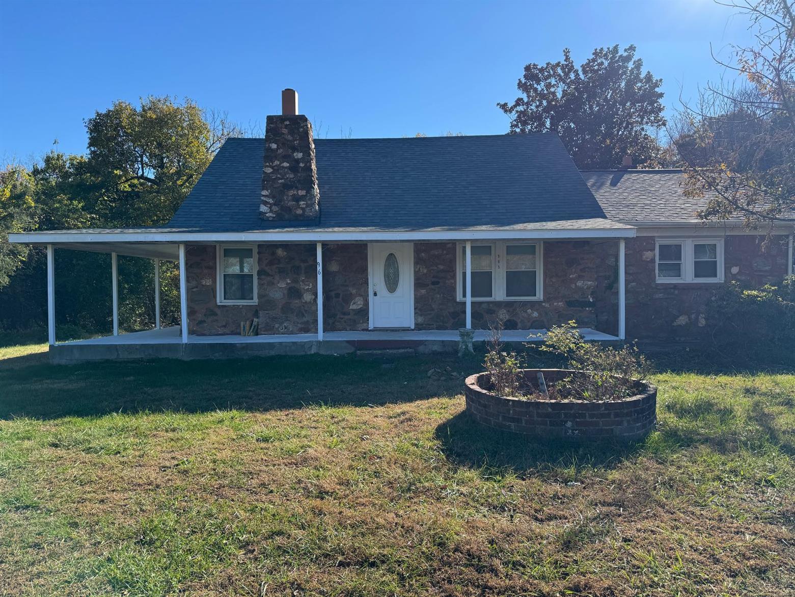 a front view of a house with a garden and plants