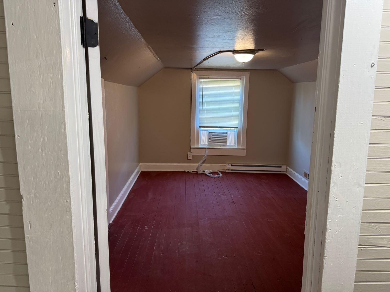 965 Hodges Farm Road Martinsville, VA 24112 - Photo 4 of 12 an empty room with wooden floor and windows