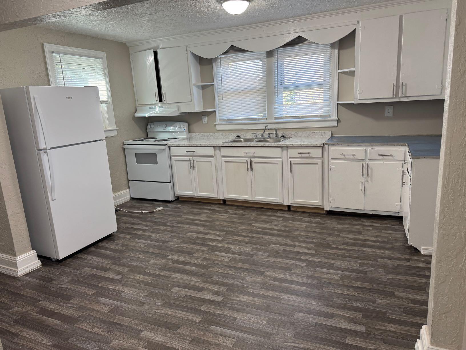 965 Hodges Farm Road Martinsville, VA 24112 - Photo 7 of 12 a kitchen with granite countertop white cabinets and white appliances