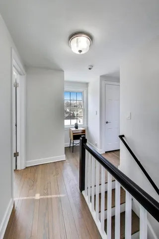 a view of an entryway with wooden floor