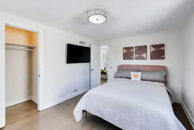 a bedroom with a bed and a flat screen tv