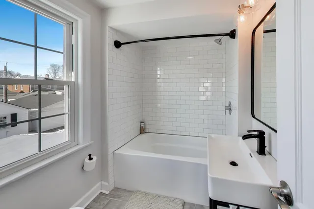 a bathroom with a bathtub and shower