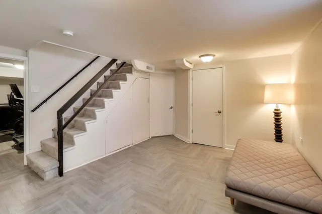 a bedroom with a bed and a chandelier