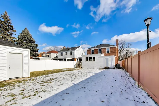 a view of a house with wooden fence