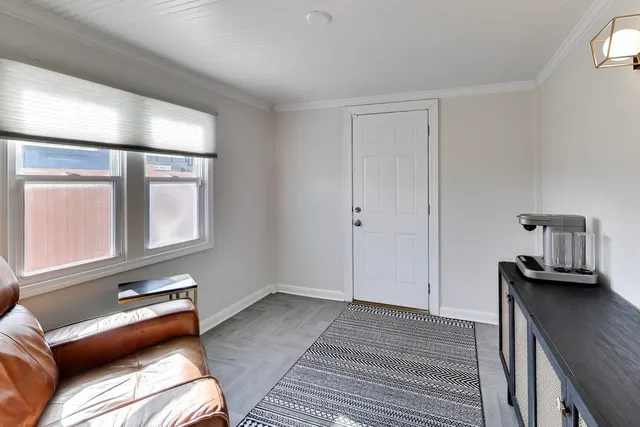 a view of a room with furniture and wooden floor