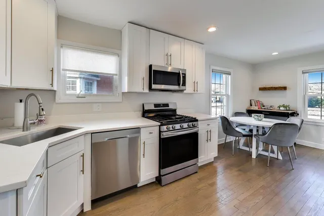 a kitchen with a sink stove and microwave