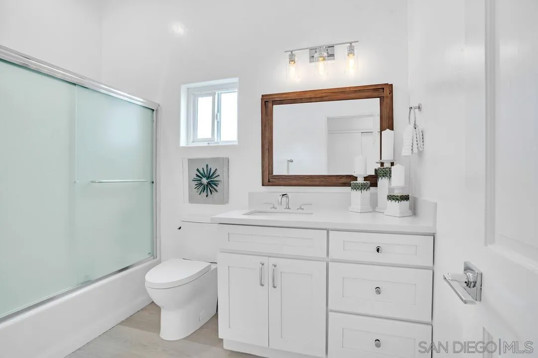 1206 Seacoast Drive, Unit C Imperial Beach, CA 91932 - Photo 12 of 32 a bathroom with a sink a toilet and a mirror