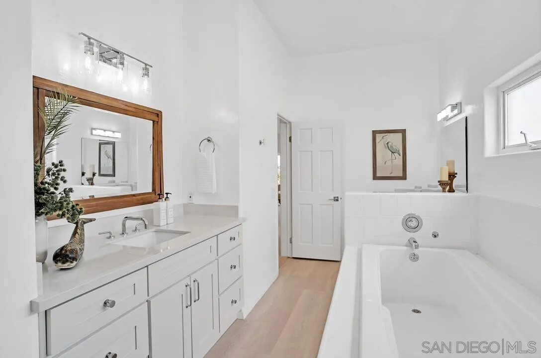 1206 Seacoast Drive, Unit C Imperial Beach, CA 91932 - Photo 19 of 32 a bathroom with a tub sink and mirror