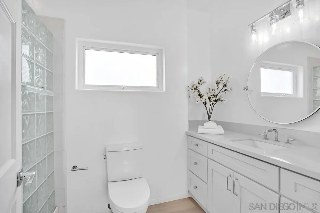 1206 Seacoast Drive, Unit C Imperial Beach, CA 91932 - Photo 20 of 32 a bathroom with a granite countertop toilet sink and mirror