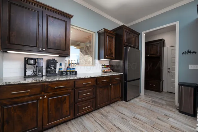 a kitchen with stainless steel appliances granite countertop a stove and a refrigerator