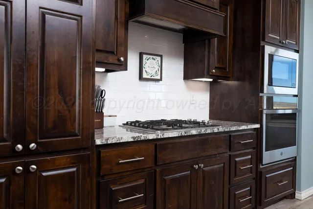 a kitchen with granite countertop a sink and a counter top space