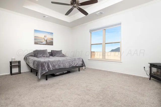a spacious bedroom with a bed and a cabinets