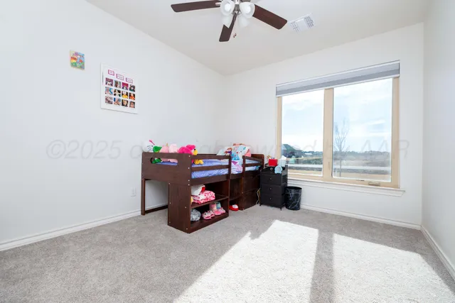 a bedroom with furniture a baby crib and a couch