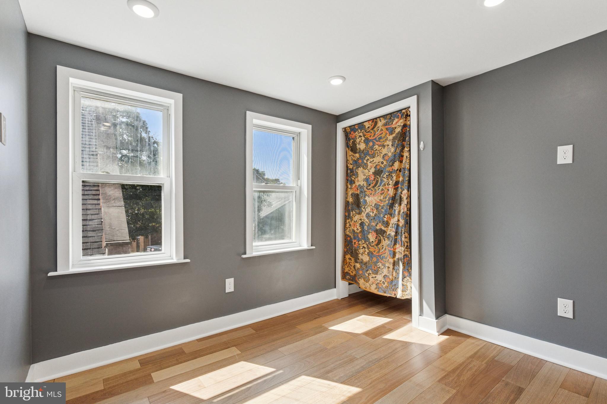 155 Sheldon Lane Ardmore, PA 19003 - Photo 13 of 17 a view of an empty room with a window and wooden floor