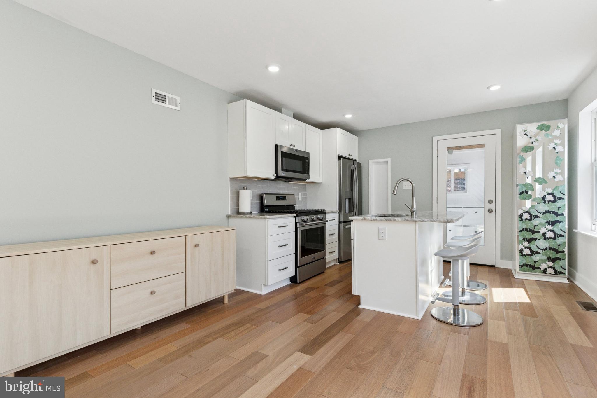 155 Sheldon Lane Ardmore, PA 19003 - Photo 5 of 17 a kitchen with white cabinets and stainless steel appliances