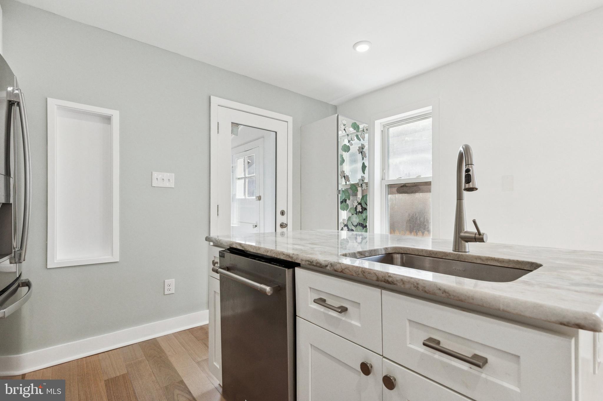 155 Sheldon Lane Ardmore, PA 19003 - Photo 8 of 17 a kitchen with granite countertop white cabinets and a sink