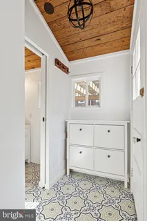 a room with a bench and cabinets