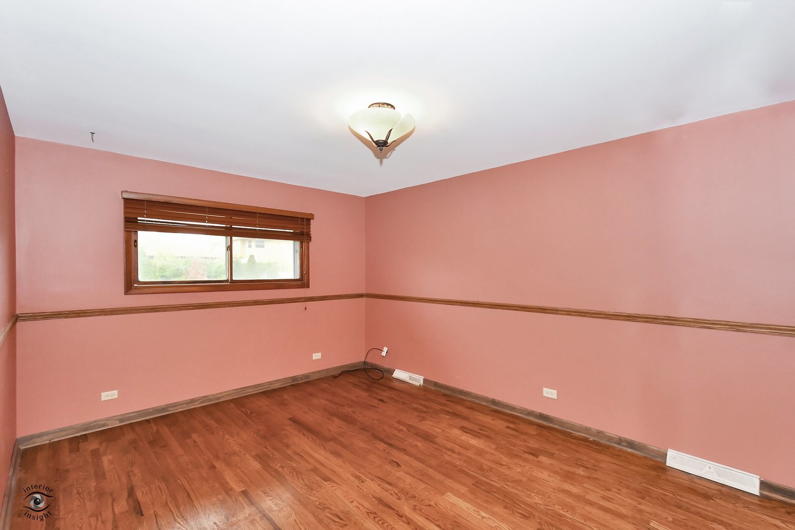 1712 Laurel Drive Mount Prospect, IL 60056 - Photo 12 of 26 a view of an empty room with a window and wooden floor