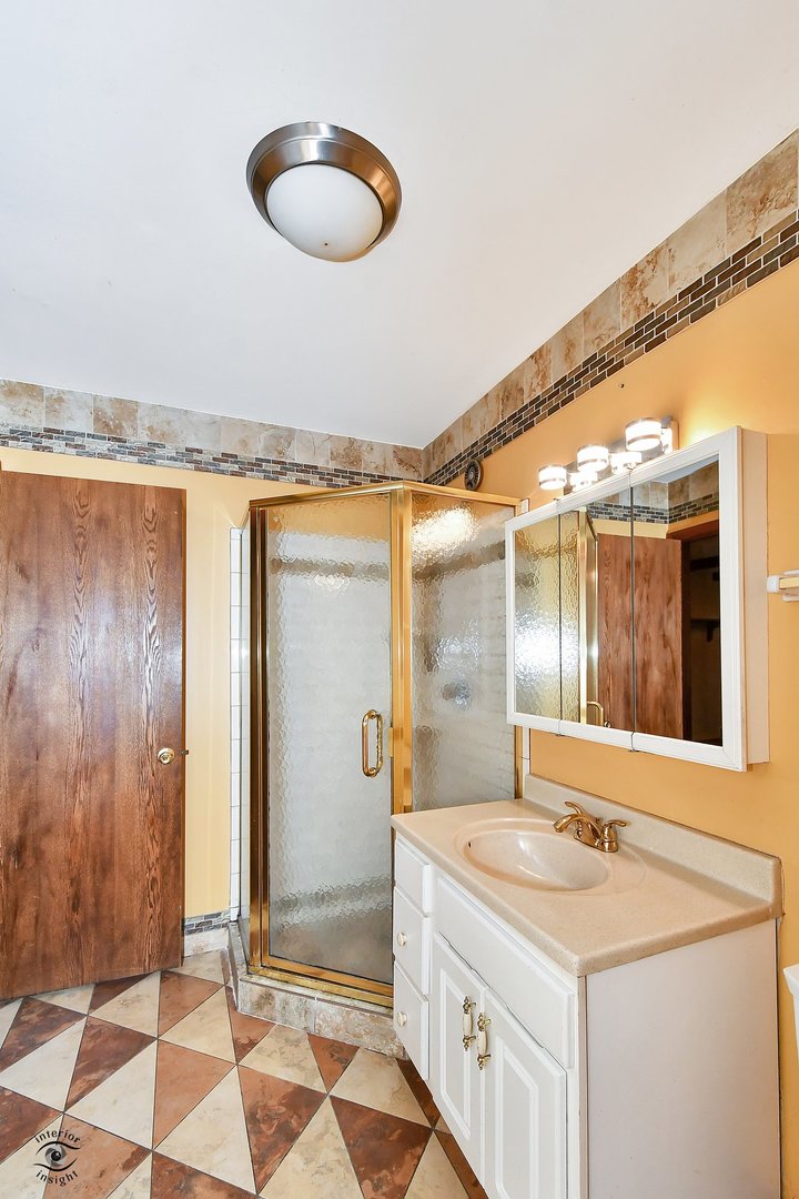1712 Laurel Drive Mount Prospect, IL 60056 - Photo 15 of 26 a bathroom with a granite countertop sink and a mirror