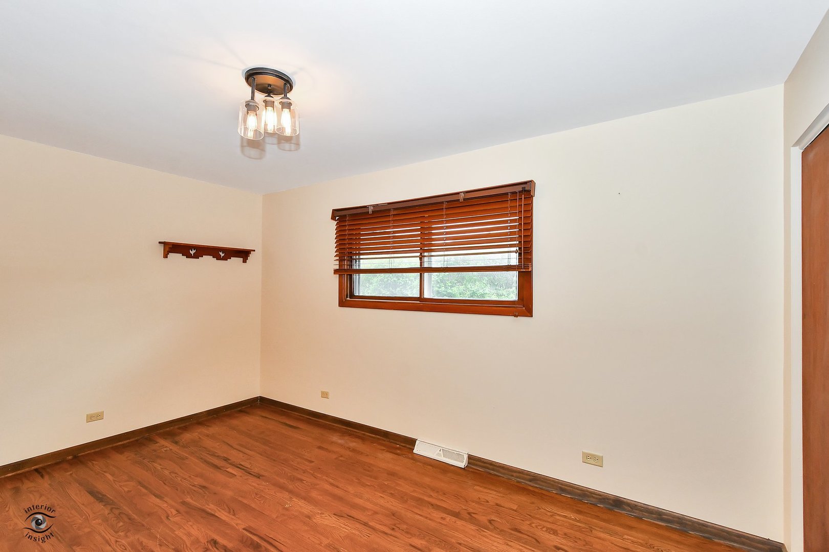 1712 Laurel Drive Mount Prospect, IL 60056 - Photo 17 of 26 an empty room with wooden floor and windows