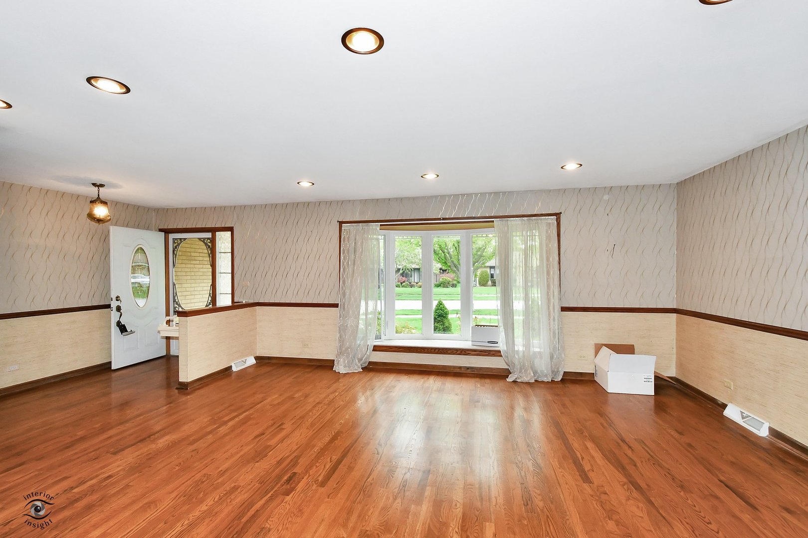 1712 Laurel Drive Mount Prospect, IL 60056 - Photo 3 of 26 a view of empty room with wooden floor and fan