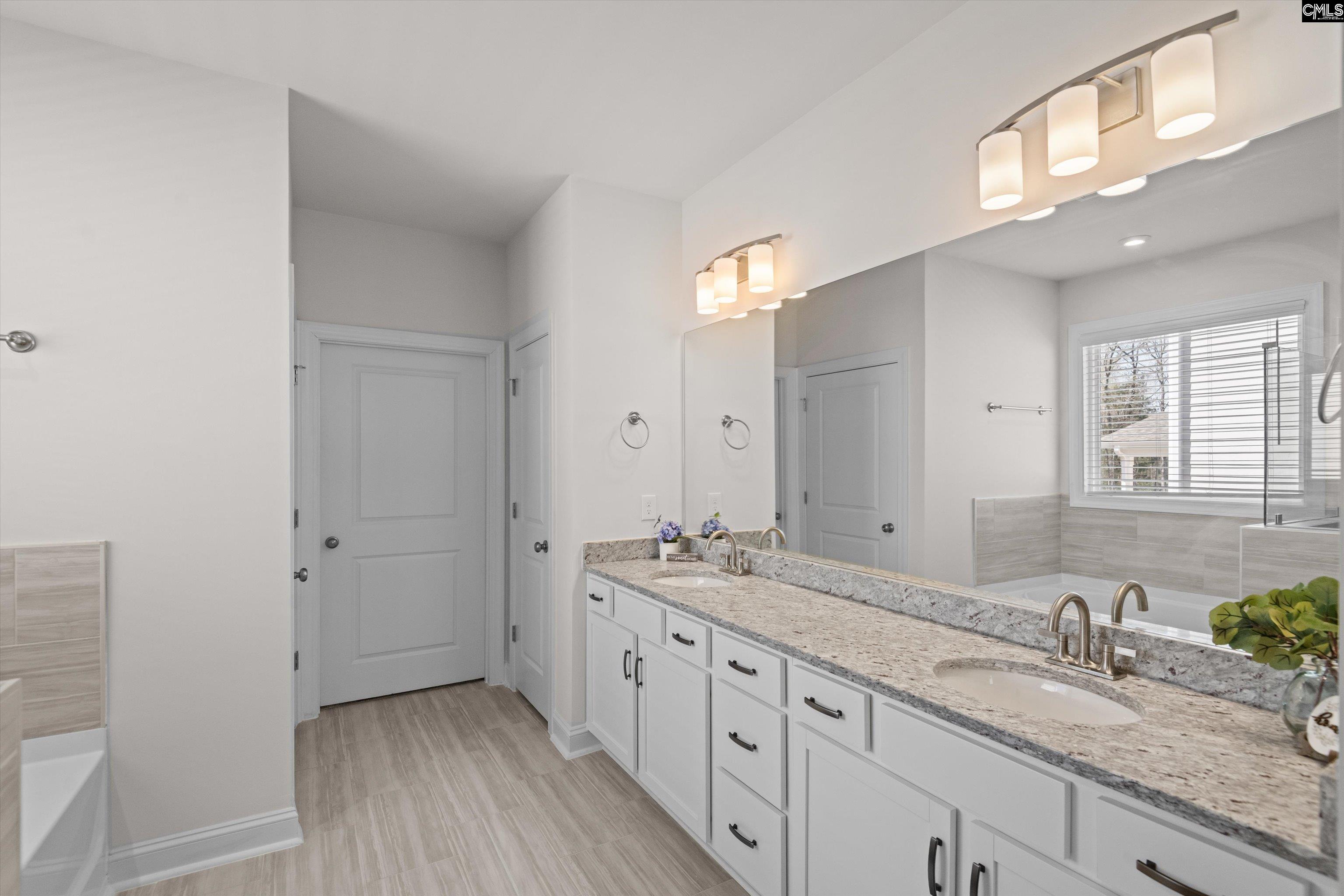 558 Wild Ginger Loop Irmo, SC 29063 - Photo 23 of 42 a bathroom with a granite countertop sink mirror and double