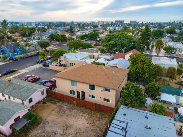 an aerial view of a house with a yard garage and lake view in back