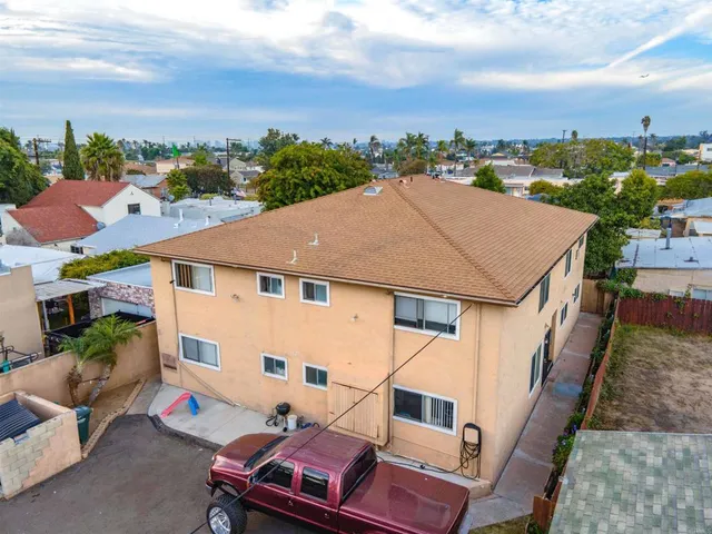 an aerial view of multiple houses with a yard