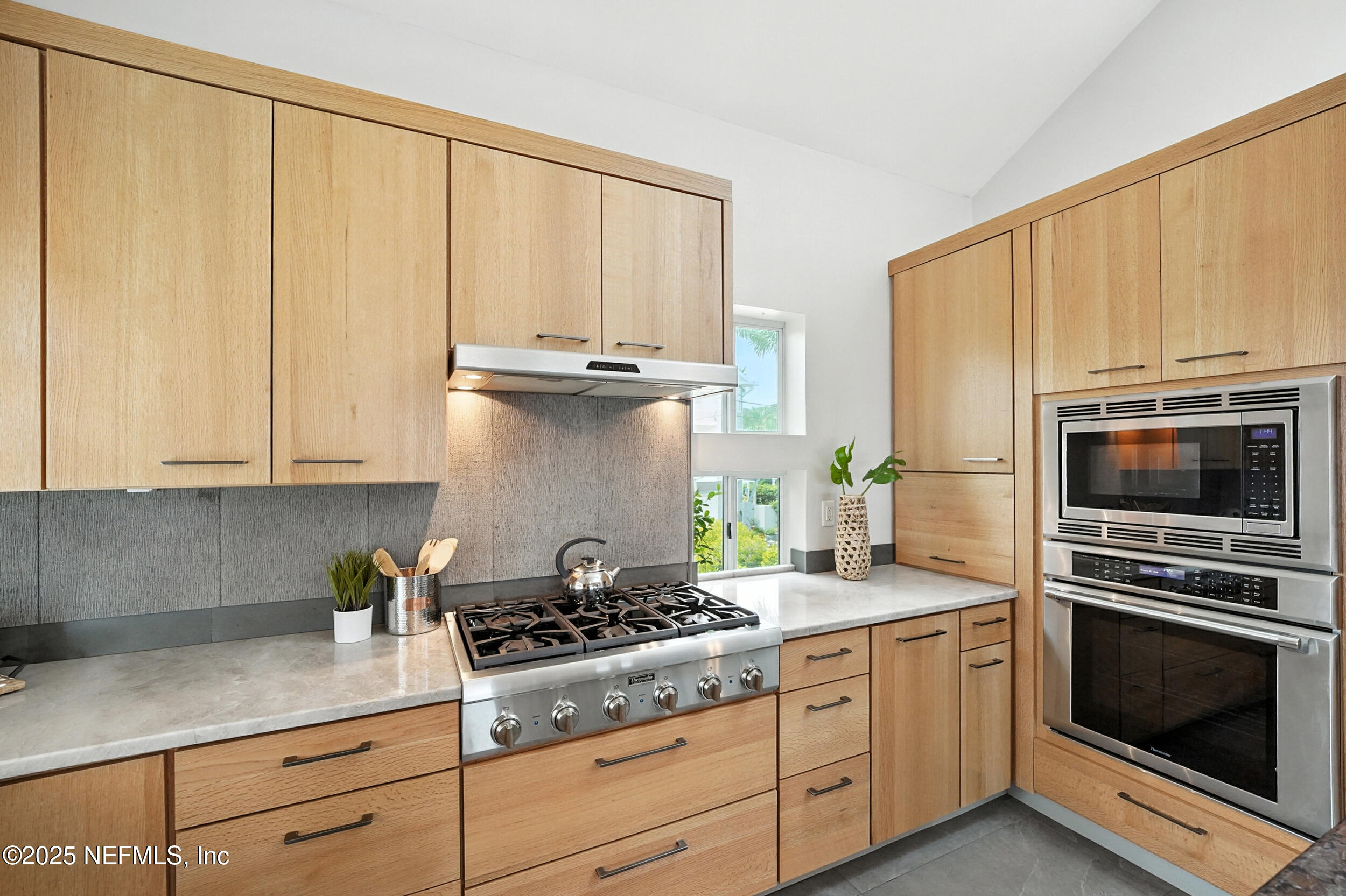 1789 Beach Avenue Atlantic Beach, FL 32233 - Photo 14 of 55 a kitchen with granite countertop a stove a sink and a microwave