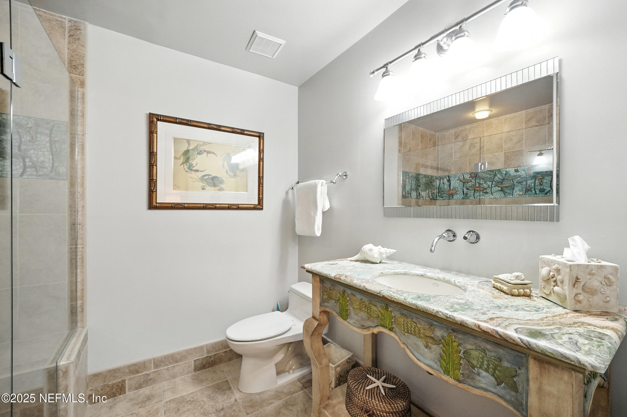 1789 Beach Avenue Atlantic Beach, FL 32233 - Photo 17 of 55 a bathroom with a granite countertop toilet sink and mirror