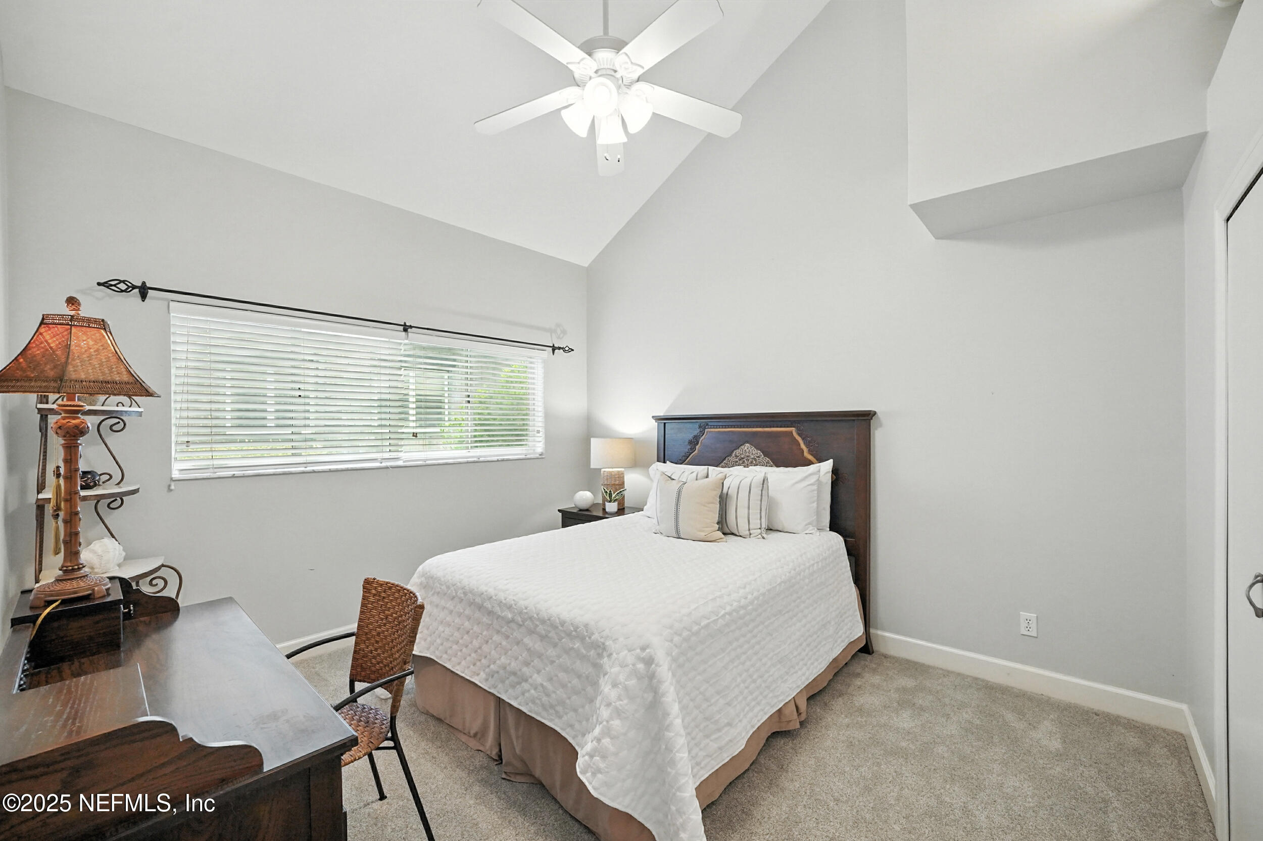 1789 Beach Avenue Atlantic Beach, FL 32233 - Photo 18 of 55 a bedroom with a bed and a table in it