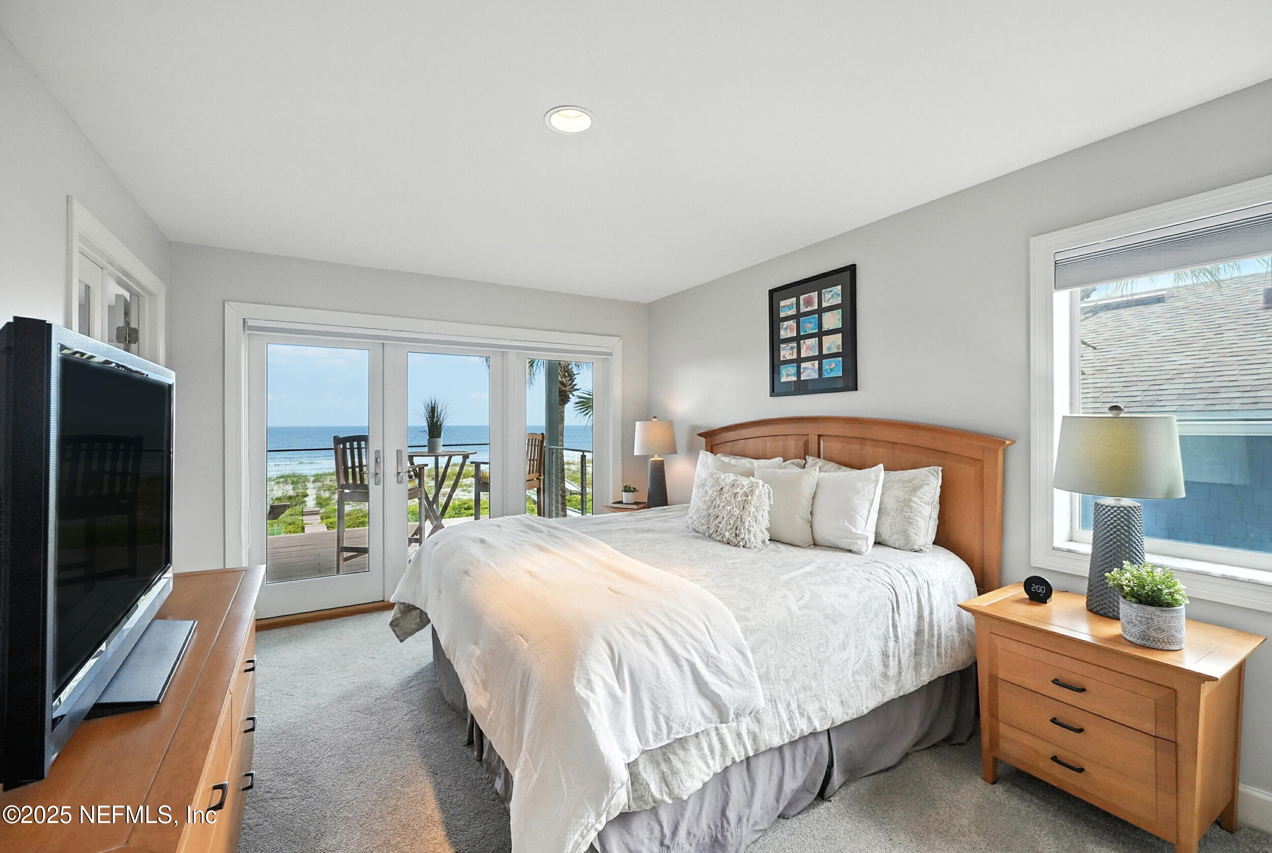 1789 Beach Avenue Atlantic Beach, FL 32233 - Photo 21 of 55 a bedroom with a bed and a flat tv screen on dresser