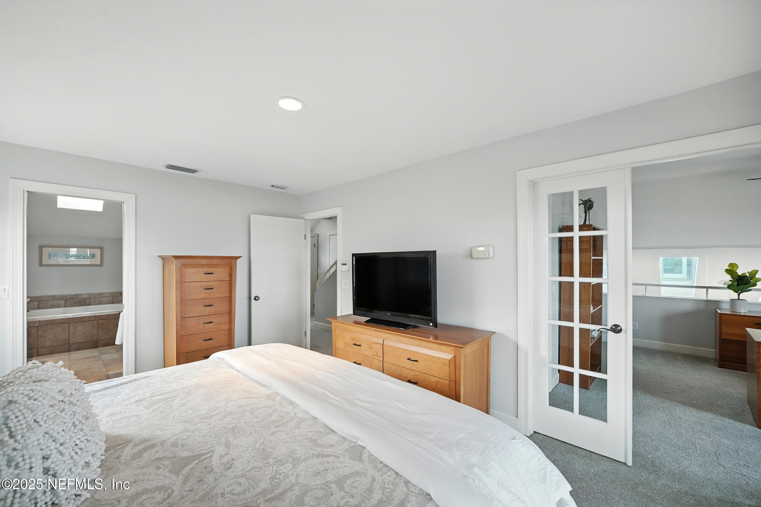 1789 Beach Avenue Atlantic Beach, FL 32233 - Photo 22 of 55 a bedroom with a bed and a flat screen tv