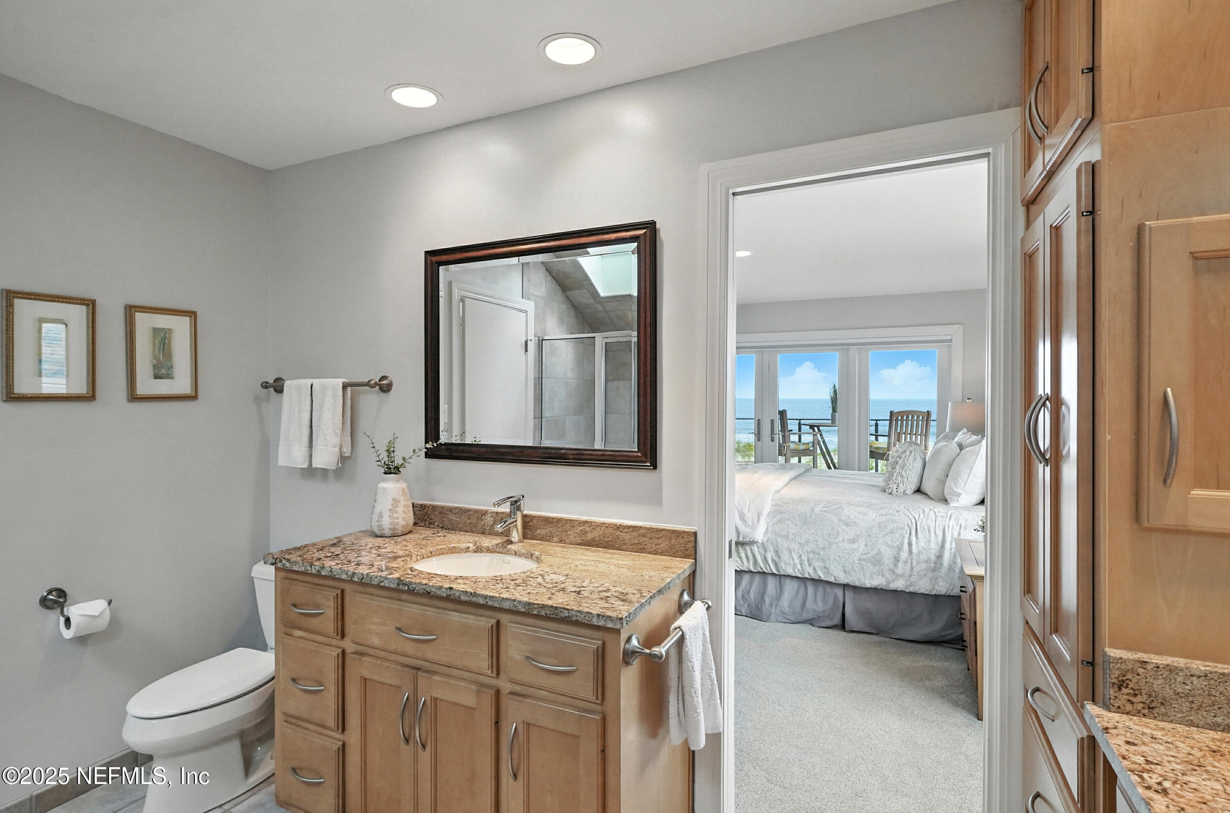 1789 Beach Avenue Atlantic Beach, FL 32233 - Photo 25 of 55 a en suite bathroom with a granite countertop sink and a mirror