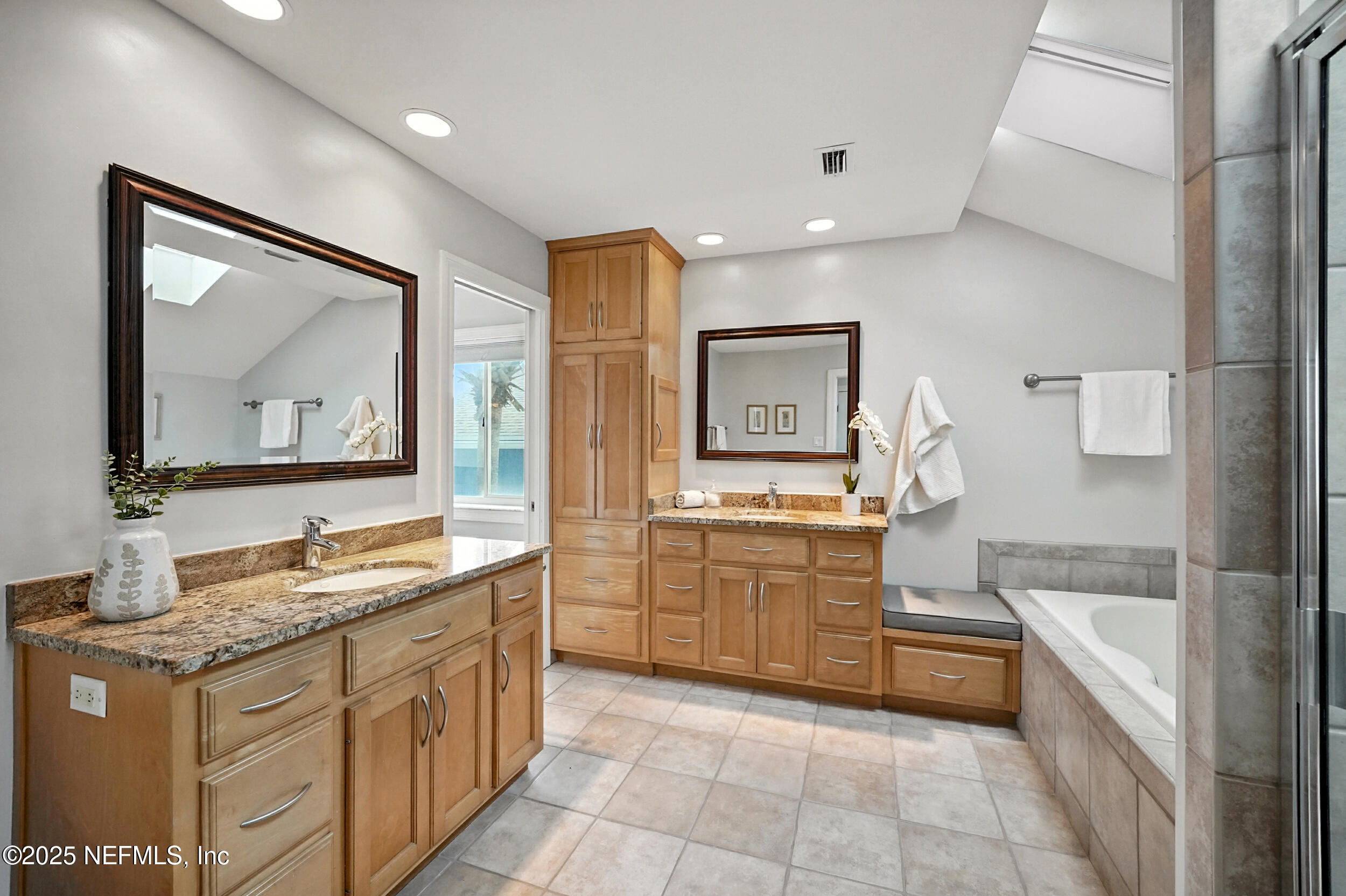1789 Beach Avenue Atlantic Beach, FL 32233 - Photo 26 of 55 a bathroom with a granite countertop double vanity sink a mirror and a bathtub