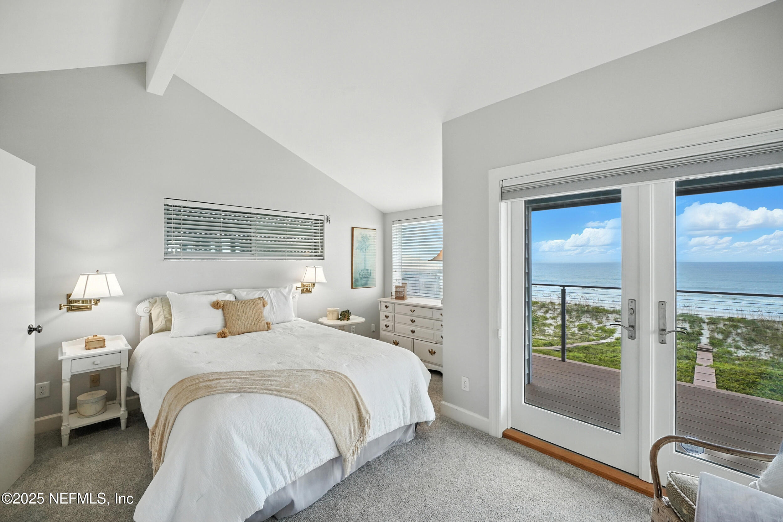 1789 Beach Avenue Atlantic Beach, FL 32233 - Photo 32 of 55 a bedroom with a bed and a large window