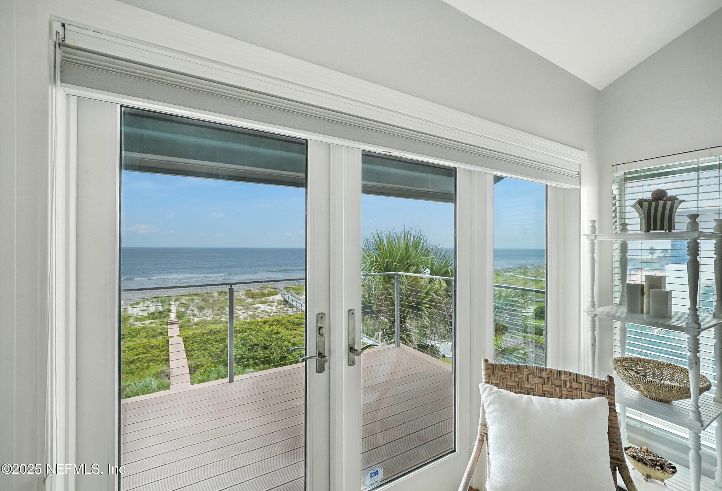 1789 Beach Avenue Atlantic Beach, FL 32233 - Photo 33 of 55 a bed room with a floor to ceiling window and wooden floor
