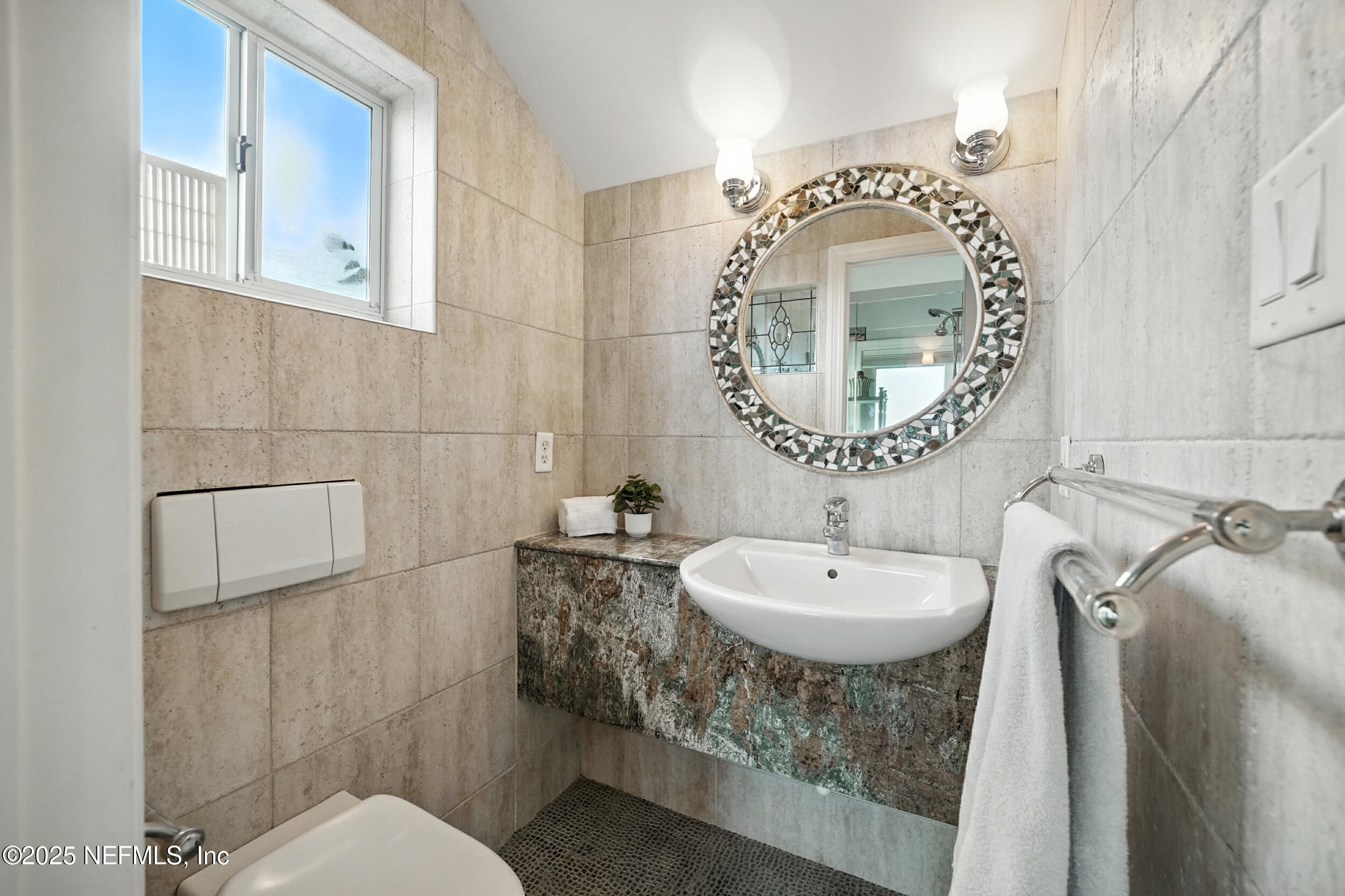 1789 Beach Avenue Atlantic Beach, FL 32233 - Photo 34 of 55 a bathroom with a toilet a sink and mirror