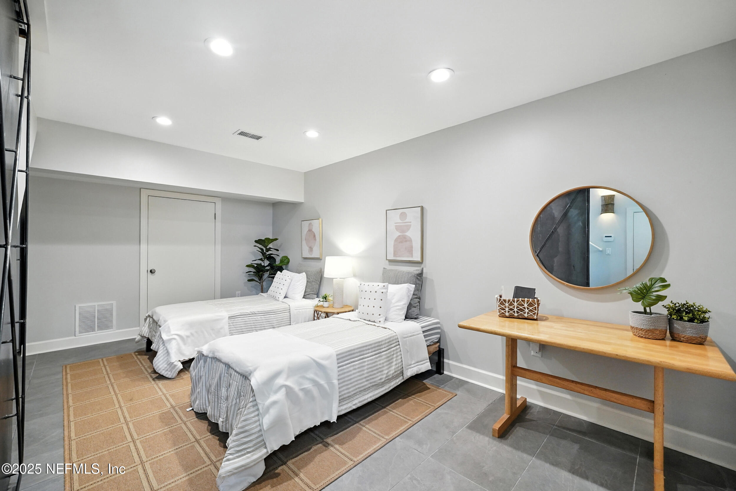 1789 Beach Avenue Atlantic Beach, FL 32233 - Photo 38 of 55 a bedroom with a bed a mirror and a lamp on dresser