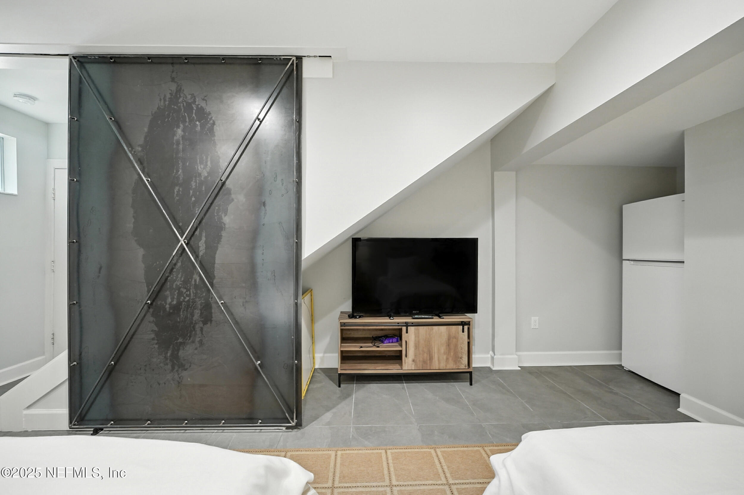 1789 Beach Avenue Atlantic Beach, FL 32233 - Photo 39 of 55 a living room with a flat screen tv and a walk in closet