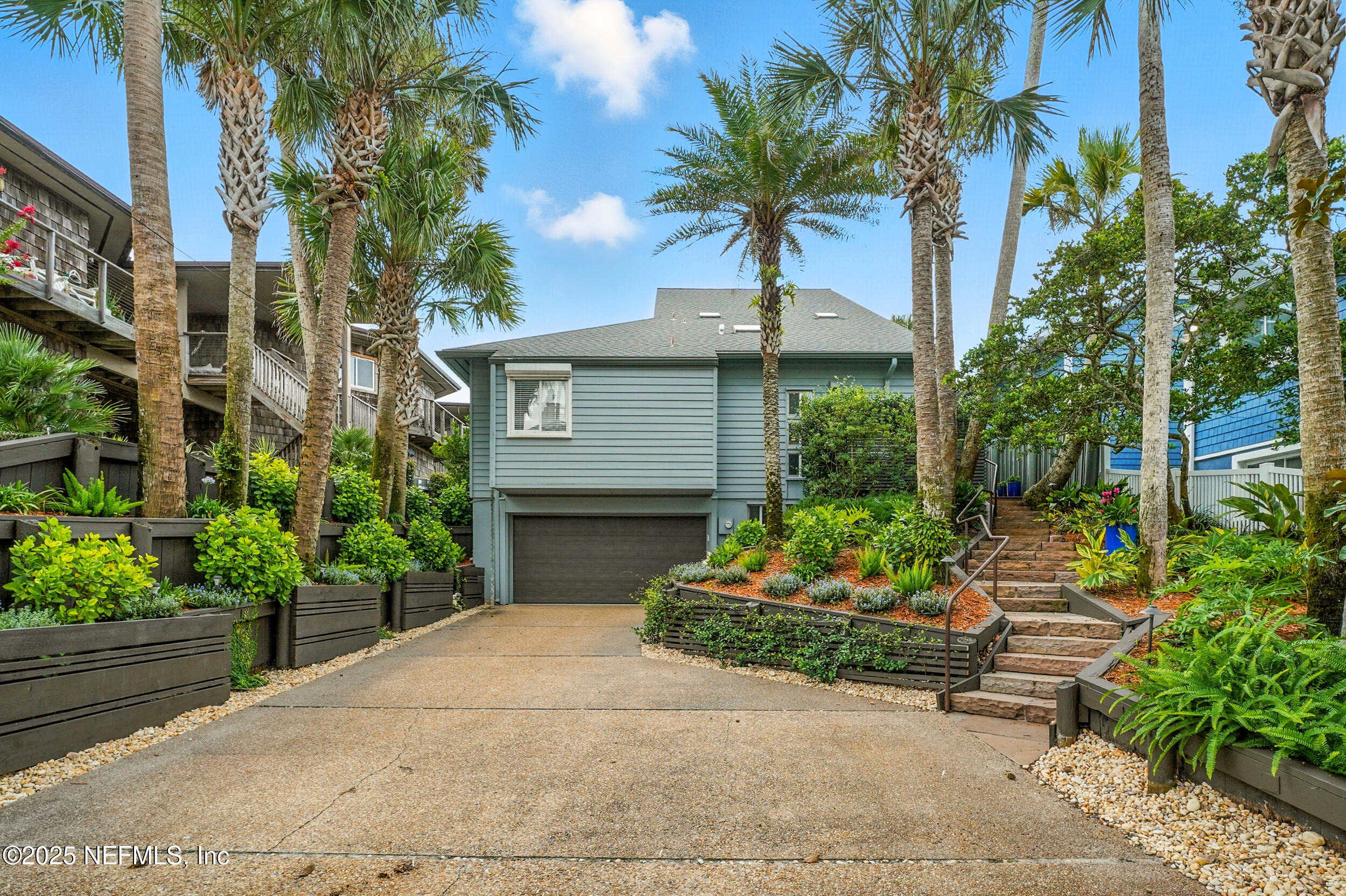 1789 Beach Avenue Atlantic Beach, FL 32233 - Photo 44 of 55 a front view of a house with a yard and a garden