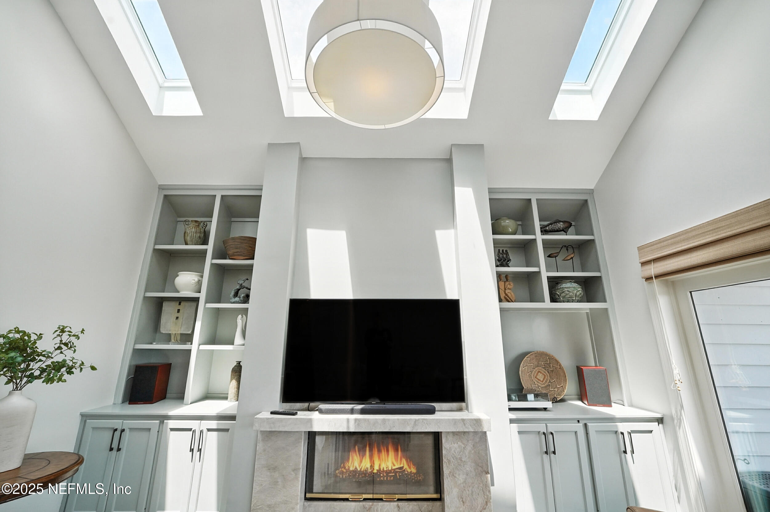 1789 Beach Avenue Atlantic Beach, FL 32233 - Photo 8 of 55 a living room with a flat screen tv and a fireplace