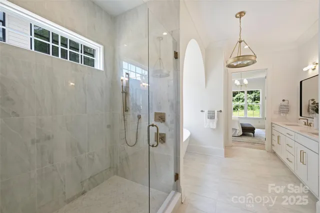 a bathroom with a granite countertop shower a mirror and a sink