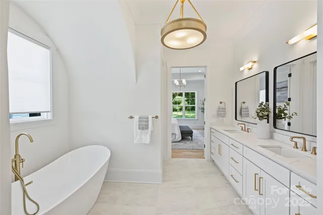 a bathroom with a tub sink and mirror