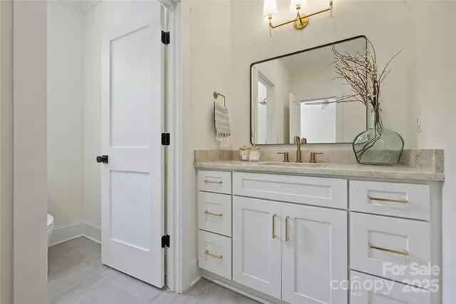 a bathroom with a double vanity sink and mirror