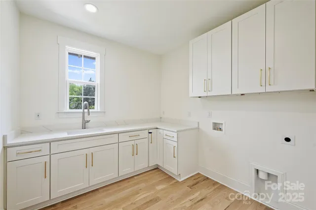 a kitchen with a sink cabinets and window