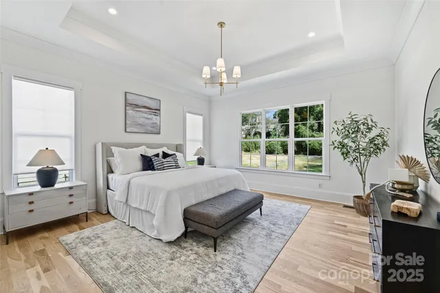 a spacious bedroom with a bed and a large window