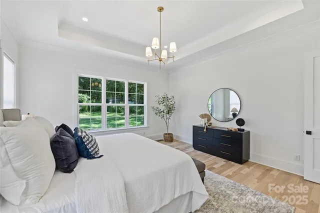 a bedroom with a bed and a chandelier