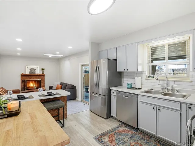 a kitchen with a sink appliances and cabinets